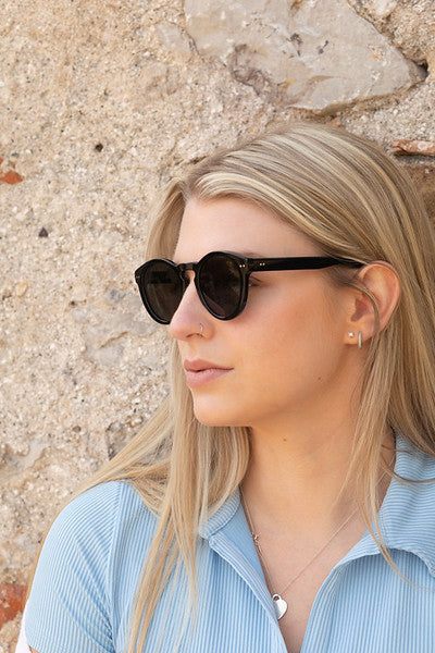 Woman in profile wearing Savona - Black with Green Lens