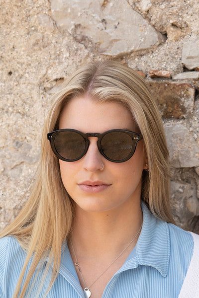 Woman wearing Savona - Black with Green Lens